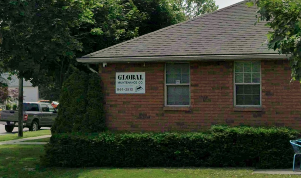 A sign on the side of a house reads "Global Maintenance"
